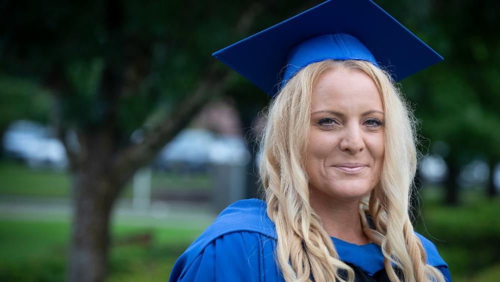 UOW Shoalhaven graduate Julia Picton, wearing a blue graduation gown and cap. Photo: Paul Jones