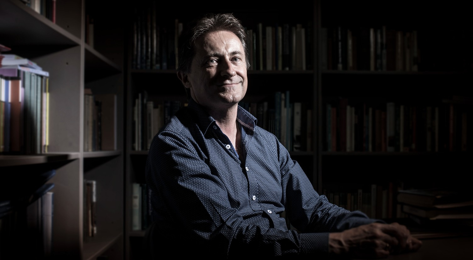 UOW Senior Professor Simon Ville, pictured against a backdrop of book shelves. Photo: Paul Jones