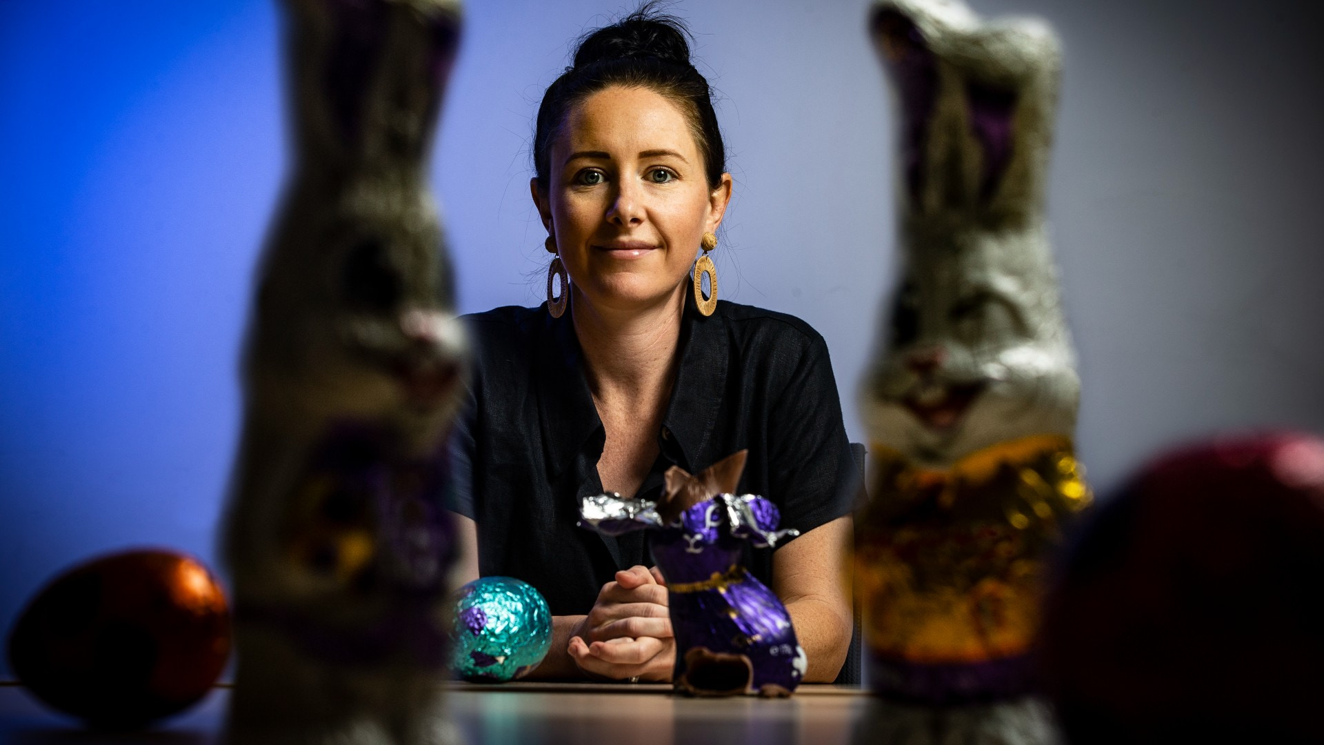 UOW researcher Dr Stephanie Perkiss sits at a table, with Easter chocolate in the foreground. Photo: Paul Jones