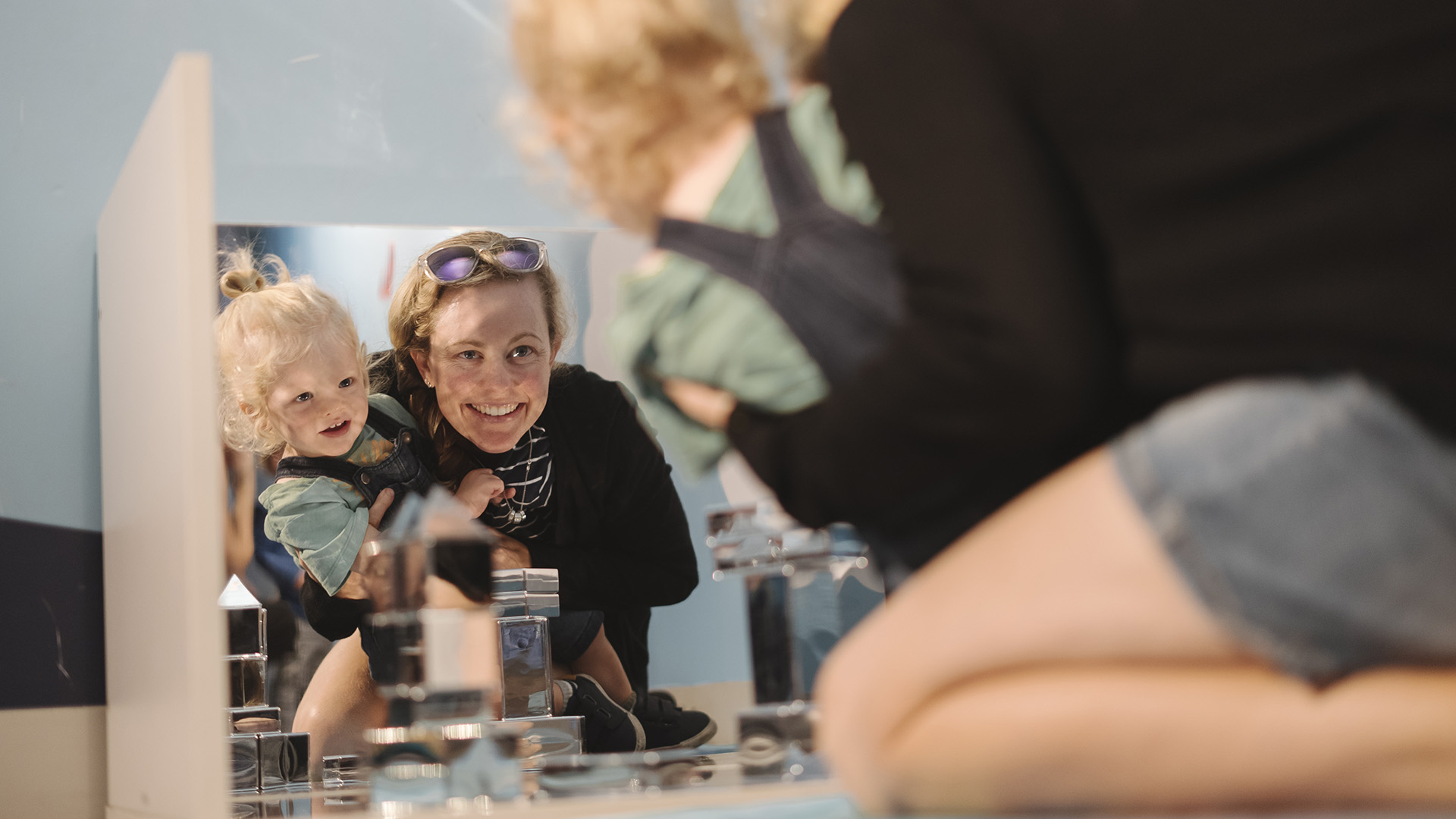 Mother and child engage with mirror play experiences at Discovery Space's The Sanctuary experience