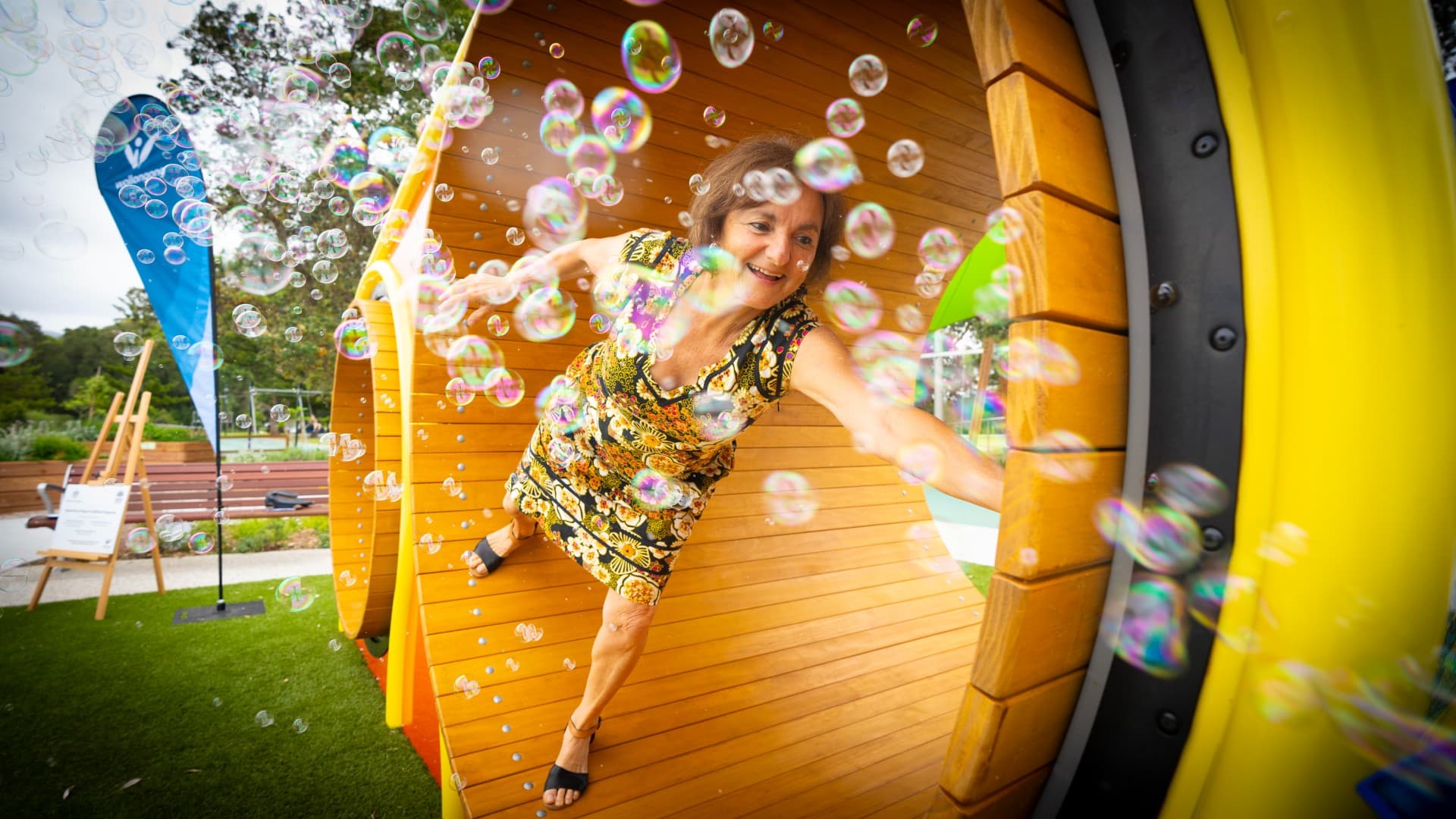 Shoshana Dreyfus uses a mouse wheel with bubbles in the foreground at the launch of a new playground in Wollongong. Photo: Paul Jones