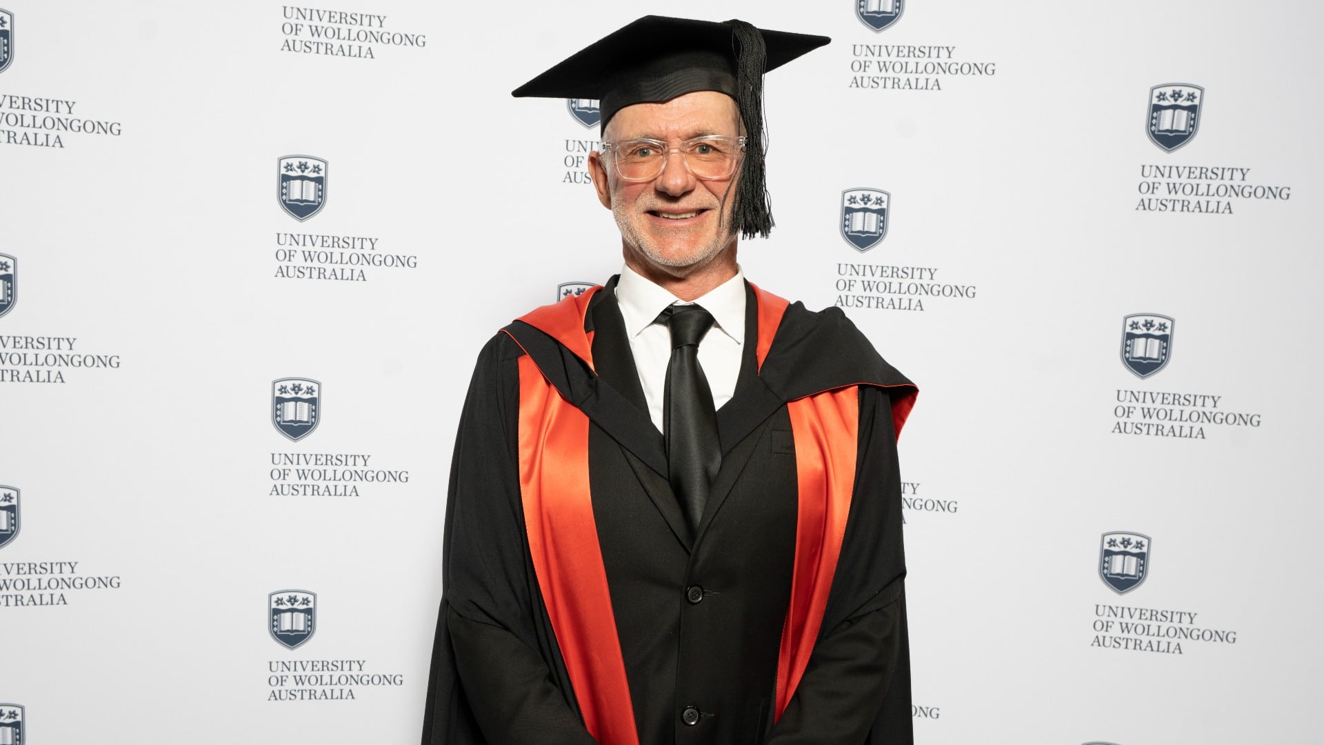 Emeritus Professor Andy Davis, wearing a black graduation cap and gown. Photo: Paul Jones
