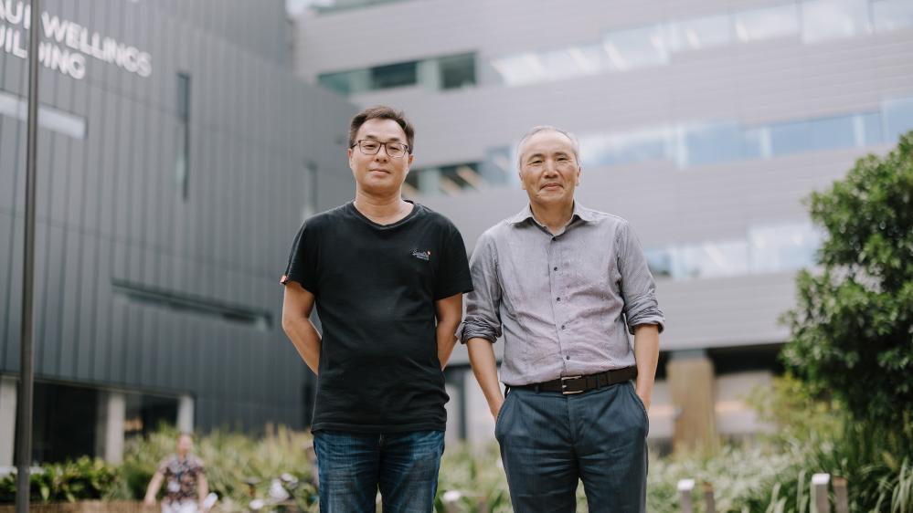 Professor Guang Shi and Dr Sam Lee stand in front of the Molecular Horizons Building. Photo: Michael Gray
