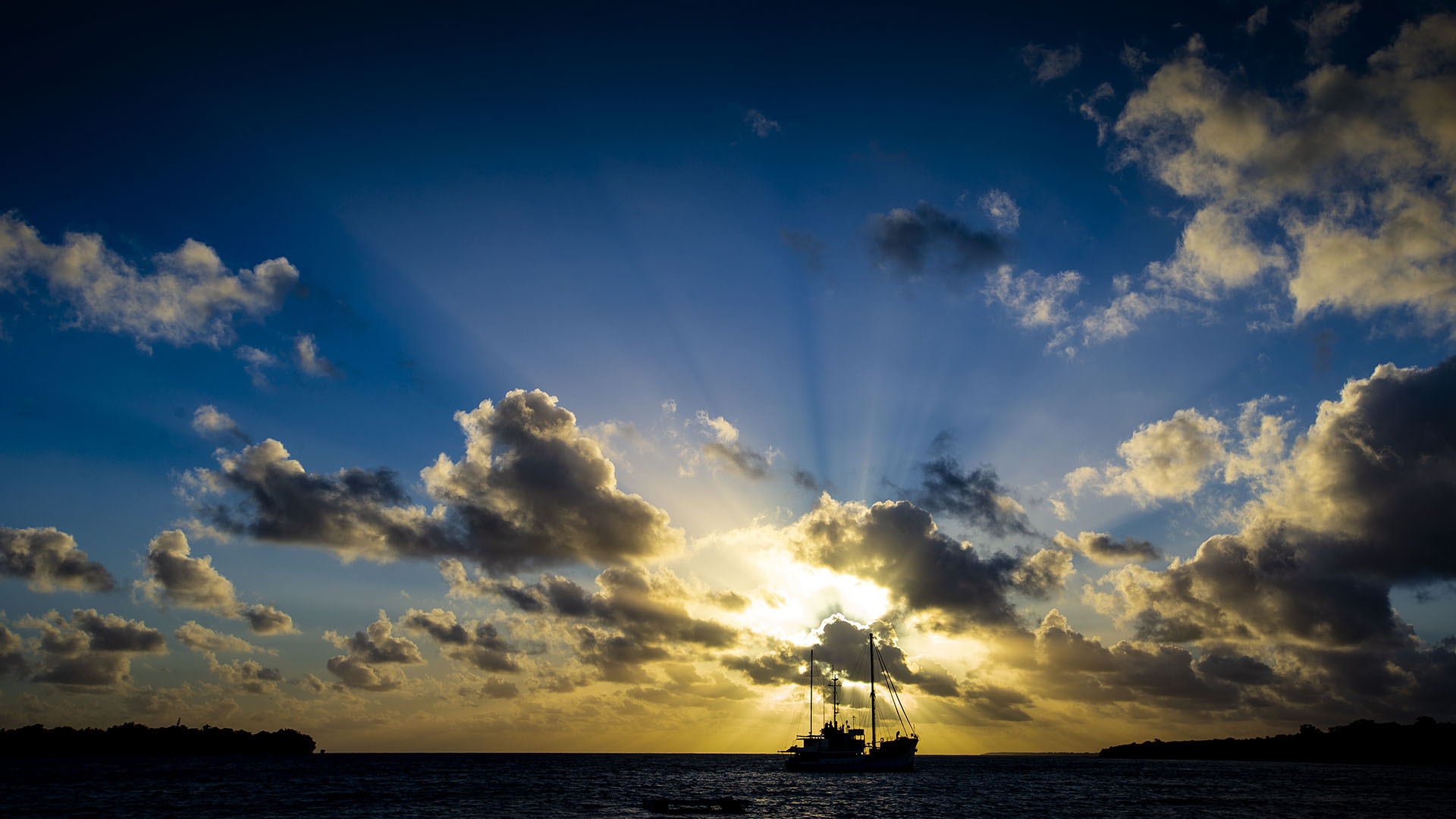 A fishing boat leaves Port Villa at dawn.