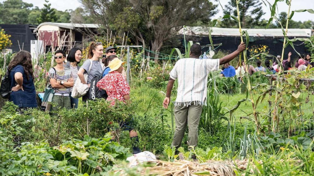 Rugare Mugumbate with a group of social work students in the garden at Dapto Community Farm. Photo: Paul Jones