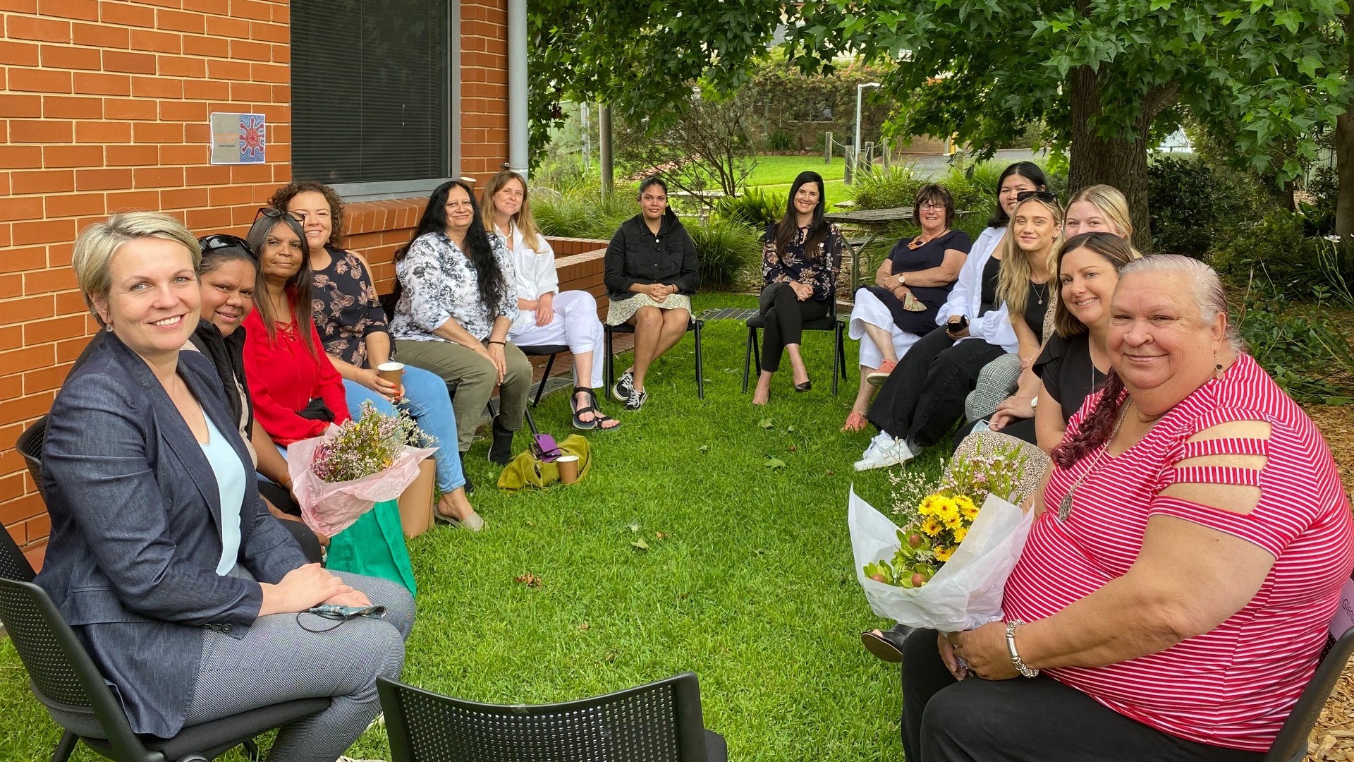 Tanya Plibersek and Kristy McBain take part in the Yarning Circle at UOW Bega. Pictured with a group of women sitting in a circle.