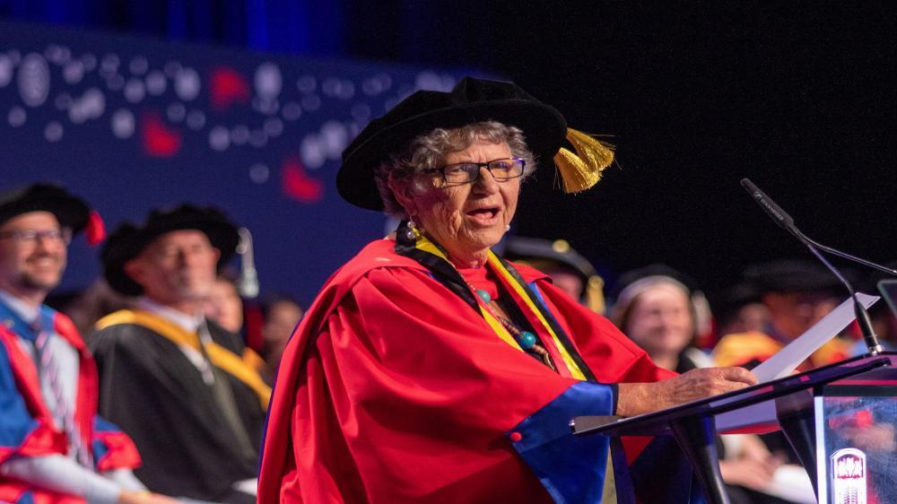Aunty Joyce Donovan delivers the Occasional Address during the graduation ceremony. She stands behind a podium. Photo: Andy Zakeli