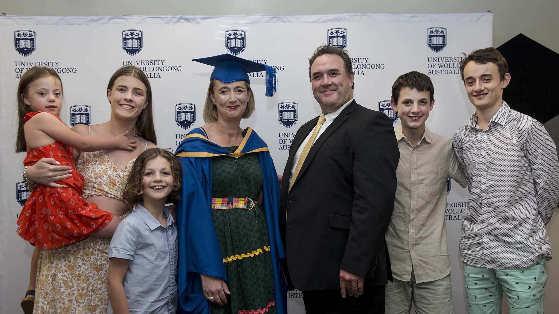 Photograph: Deborah Combes celebrating with family on at her graduation ceremony after completing a Master of Teaching degree at UOW Shoalhaven.
