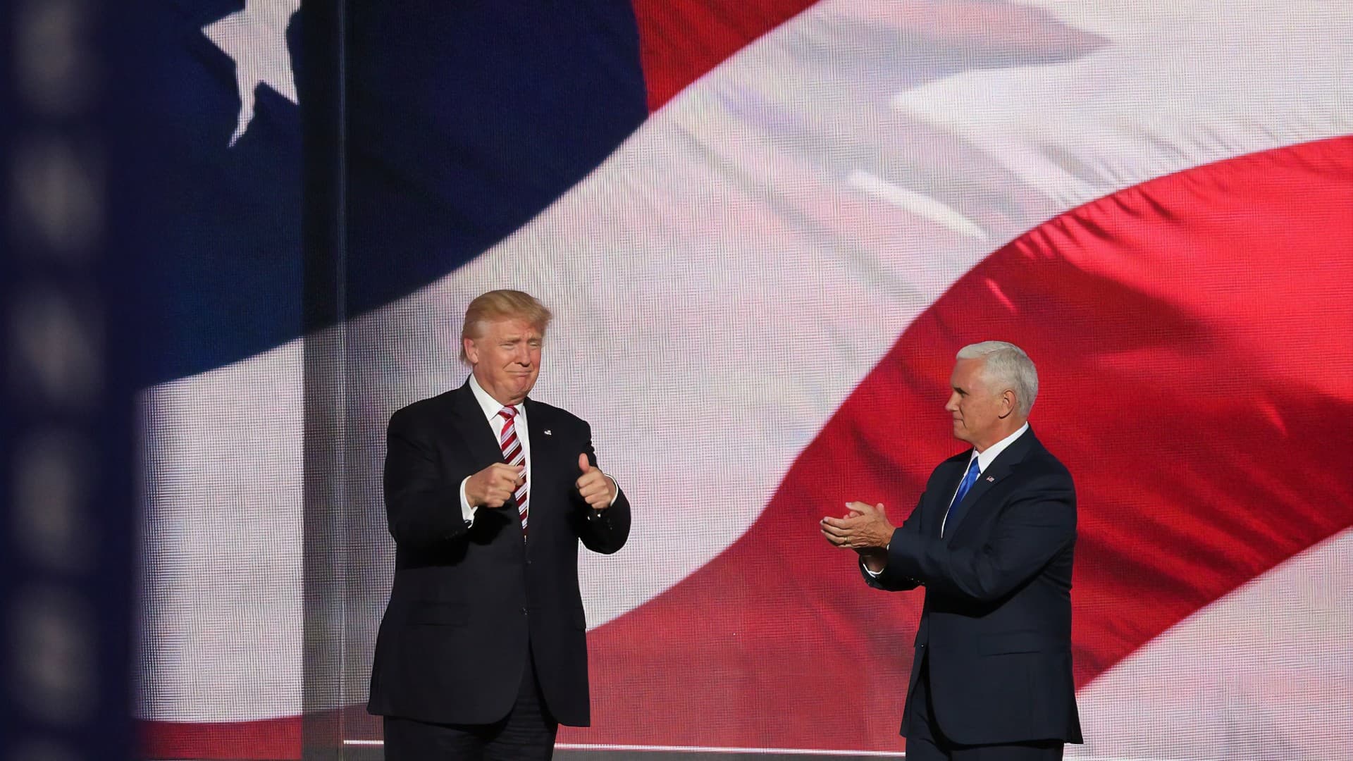 An image of President Donald Trump on stage, against an American flag, with Vice President Mike Pence. Photo: Unpslash