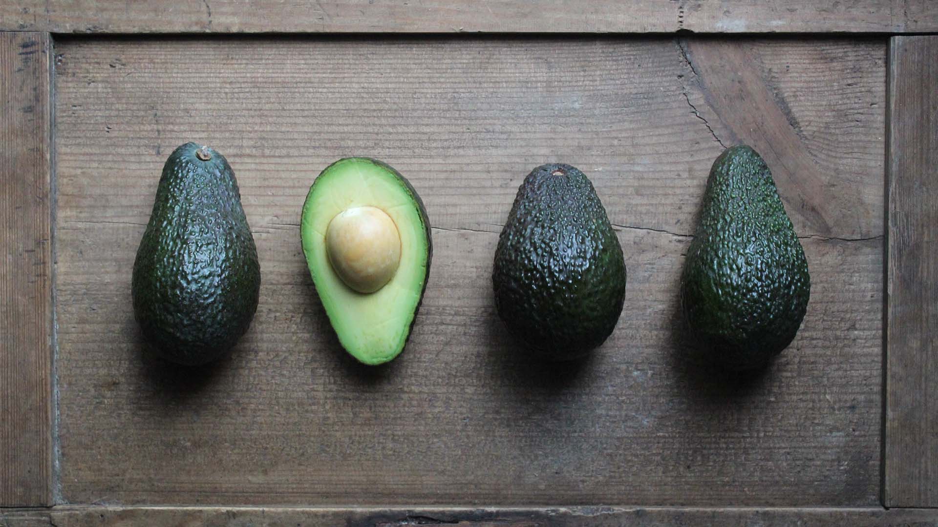 Avocados displayed on the wood