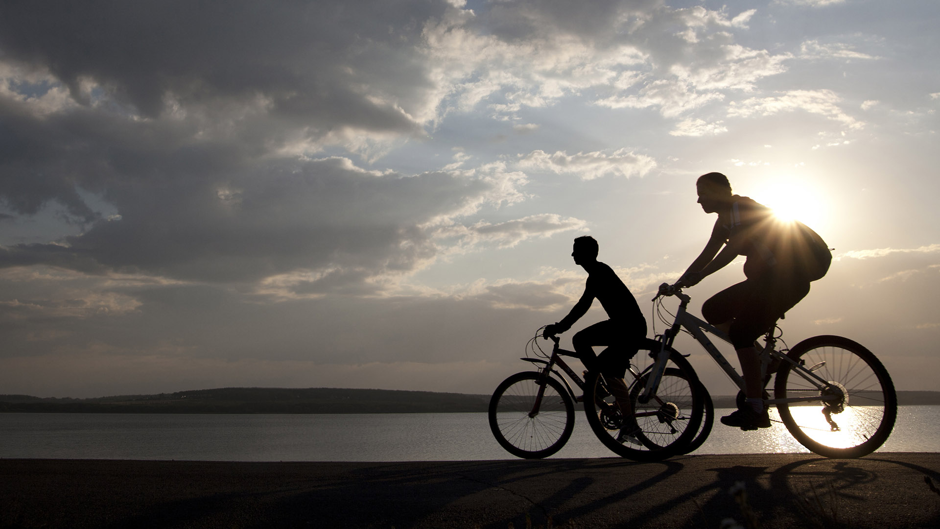 Bicycle riders at sunset. Shutterstock image