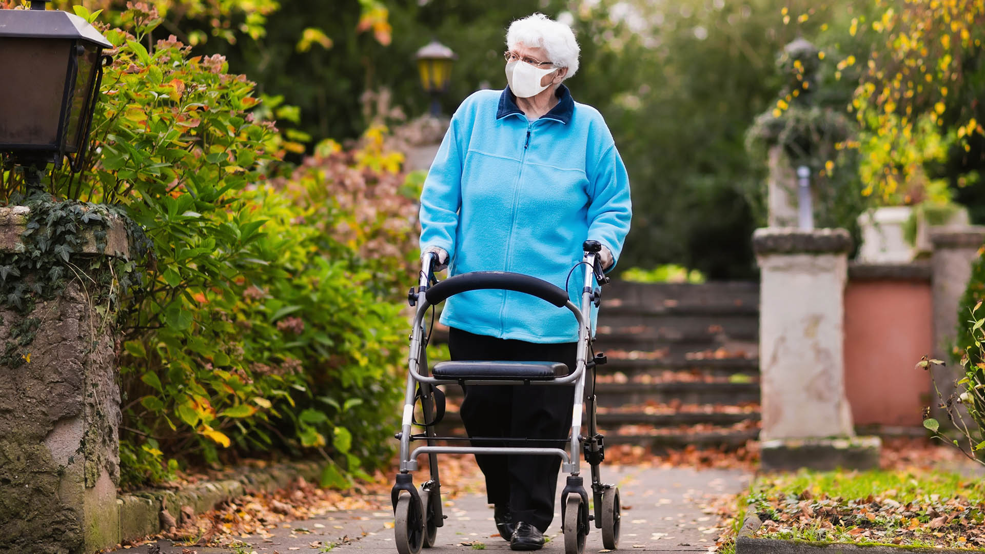 Generic photo of an older woman with a walker and face mask. Picture from Shutterstock
