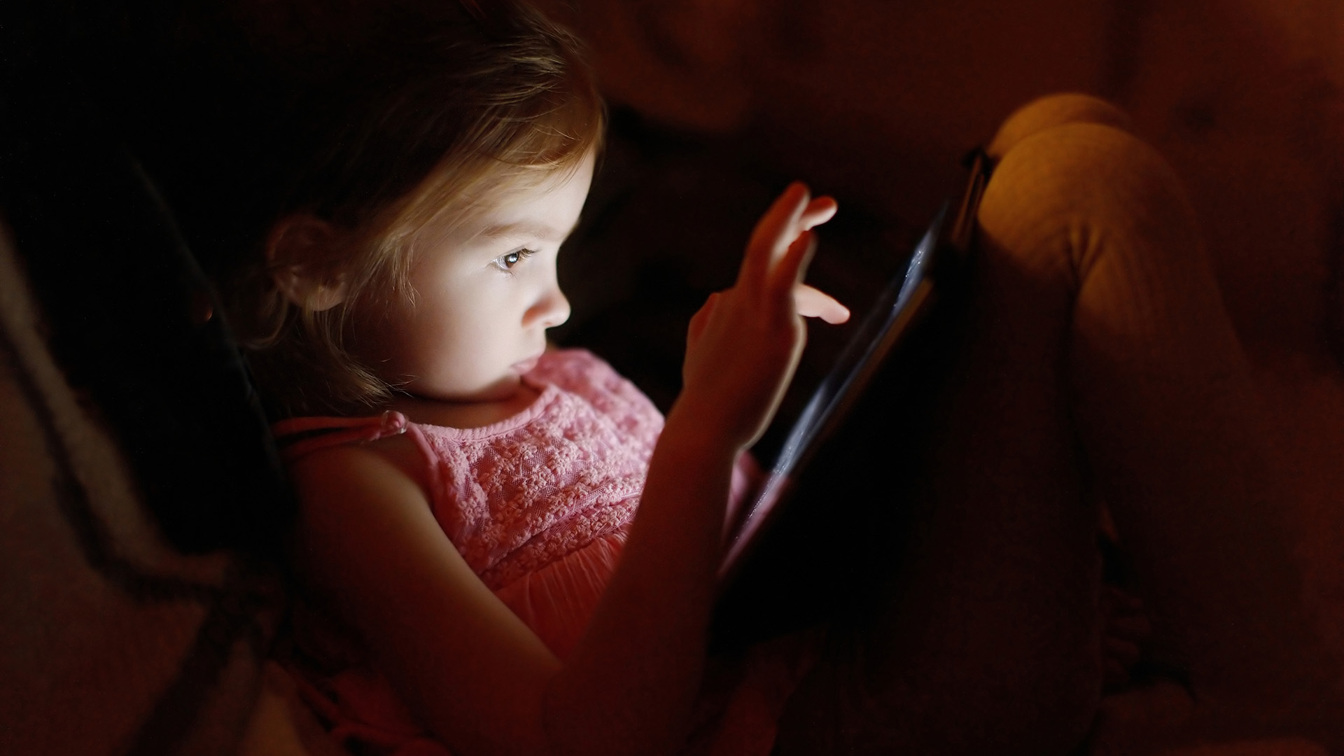 Young girl playing with digital tablet