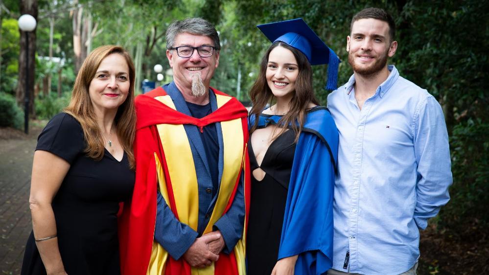 Eileen Wallace, pictured with her family, her mother Vicky, her father Gordon, wearing graduation dress. Photo: Paul Jones