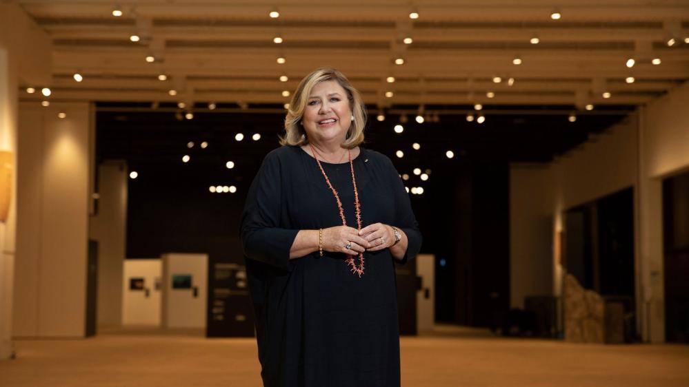 Australian Museum Director Kim McKay standing in front of a museum exhibition smiling. Picture supplied by Australian Museum