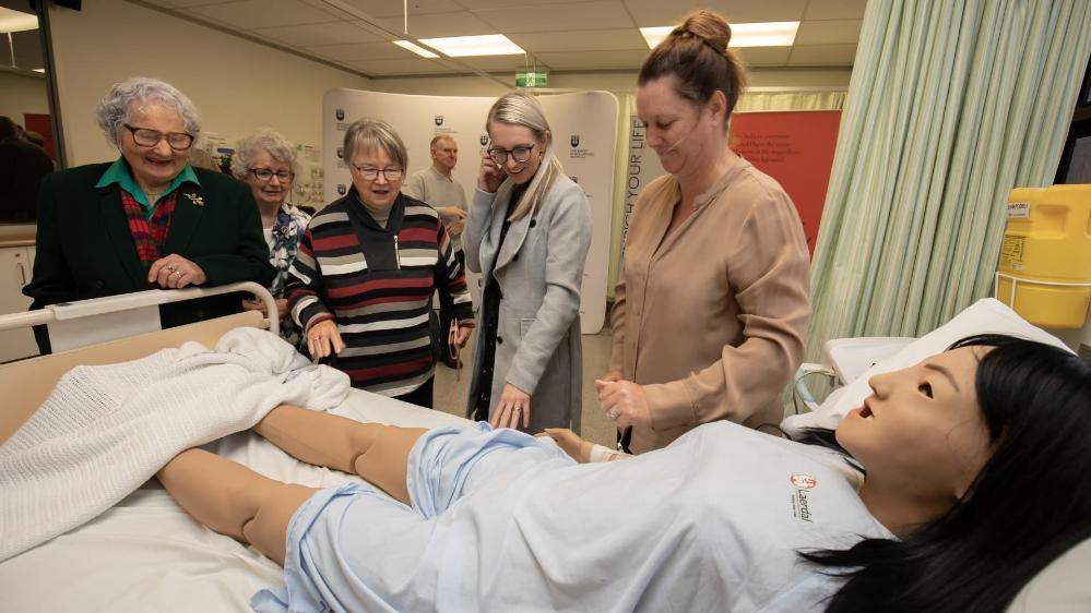 Members of the Order of the Eastern Star with representatives from UOW, pictured with the nursing simulator model. Photo: