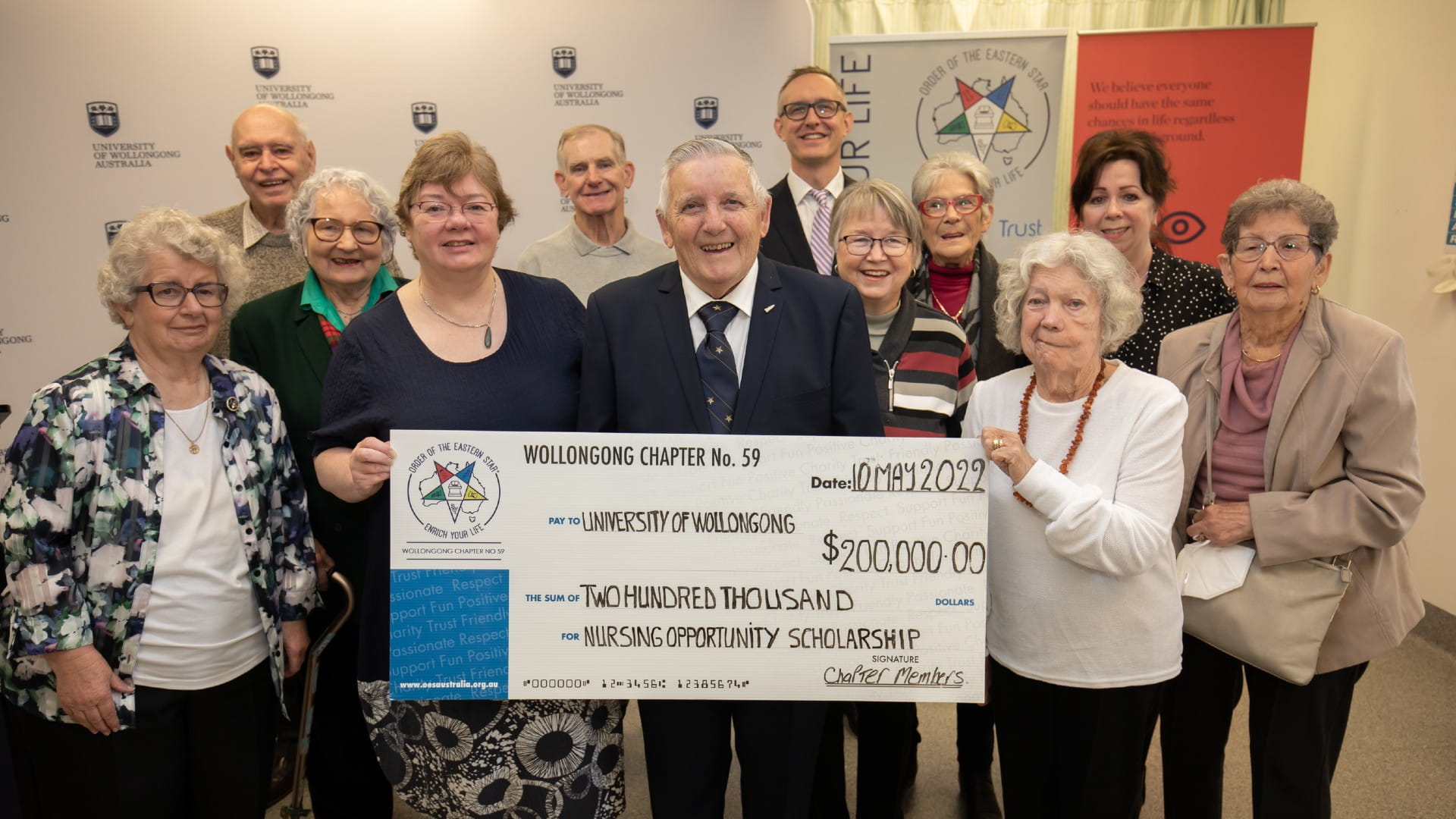 Members of the Order of the Eastern Star with representatives from UOW, hold a giant cheque at the scholarship launch. Photo: