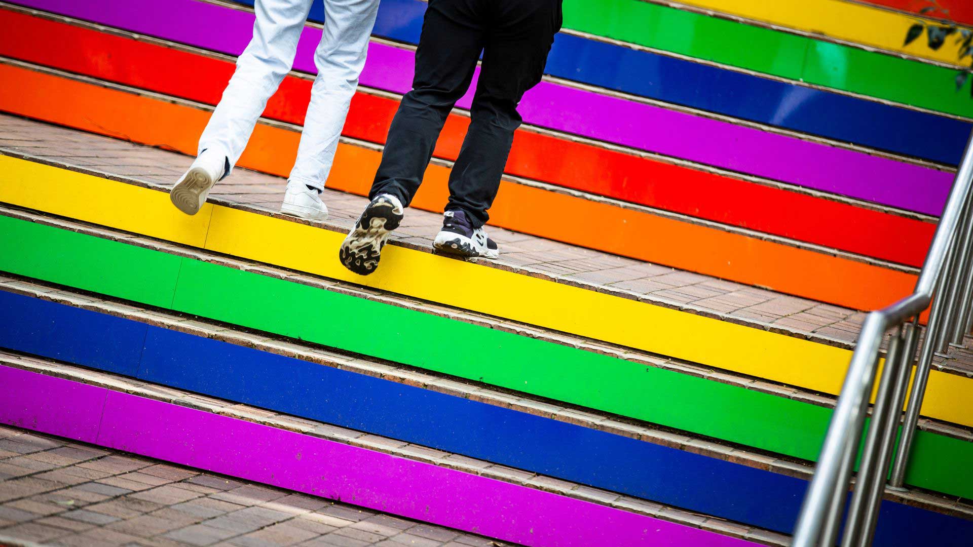 Two people walking up the permanent Rainbow Stairs at UOW. Photo: Paul Jones