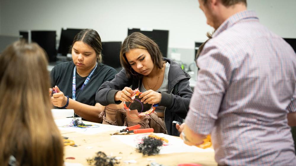 Two students from Woolyungah Summer Camp work on their creations at UOW Makerspace. Photo: Paul Jones