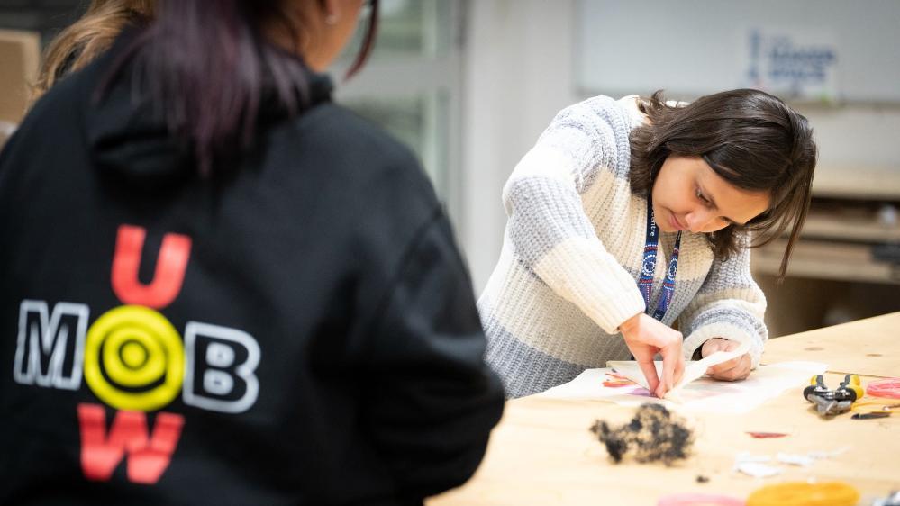 A student from Woolyungah Summer Camp examines her creation at UOW Makerspace while another student looks on. Photo: Paul Jones