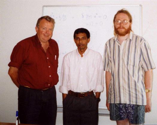 Professor Graeme C. Wake, Dr Easwaran Balakrishnan,
              and MIN standing infront of a white board, January 1999